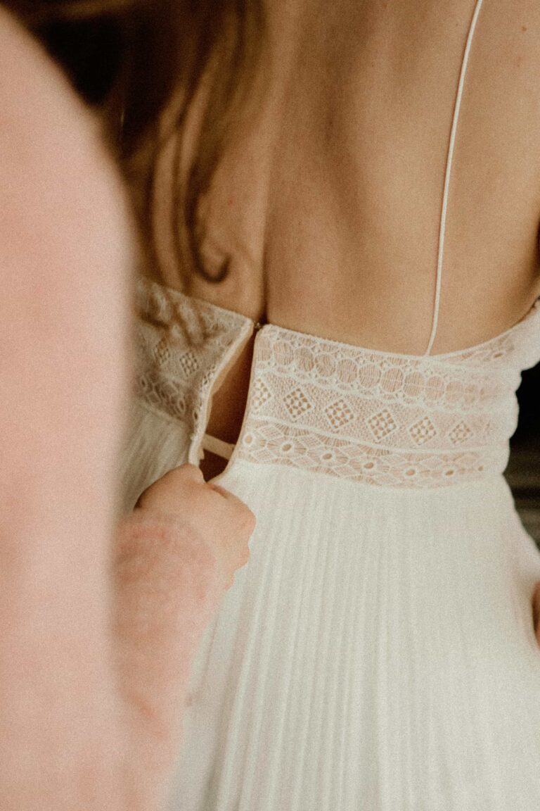 wedding dress getting zipped in analog look