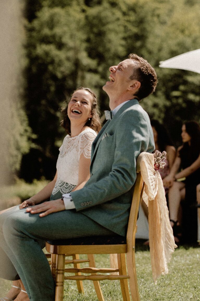 couple laughing at ceremony in the sun in vintage look