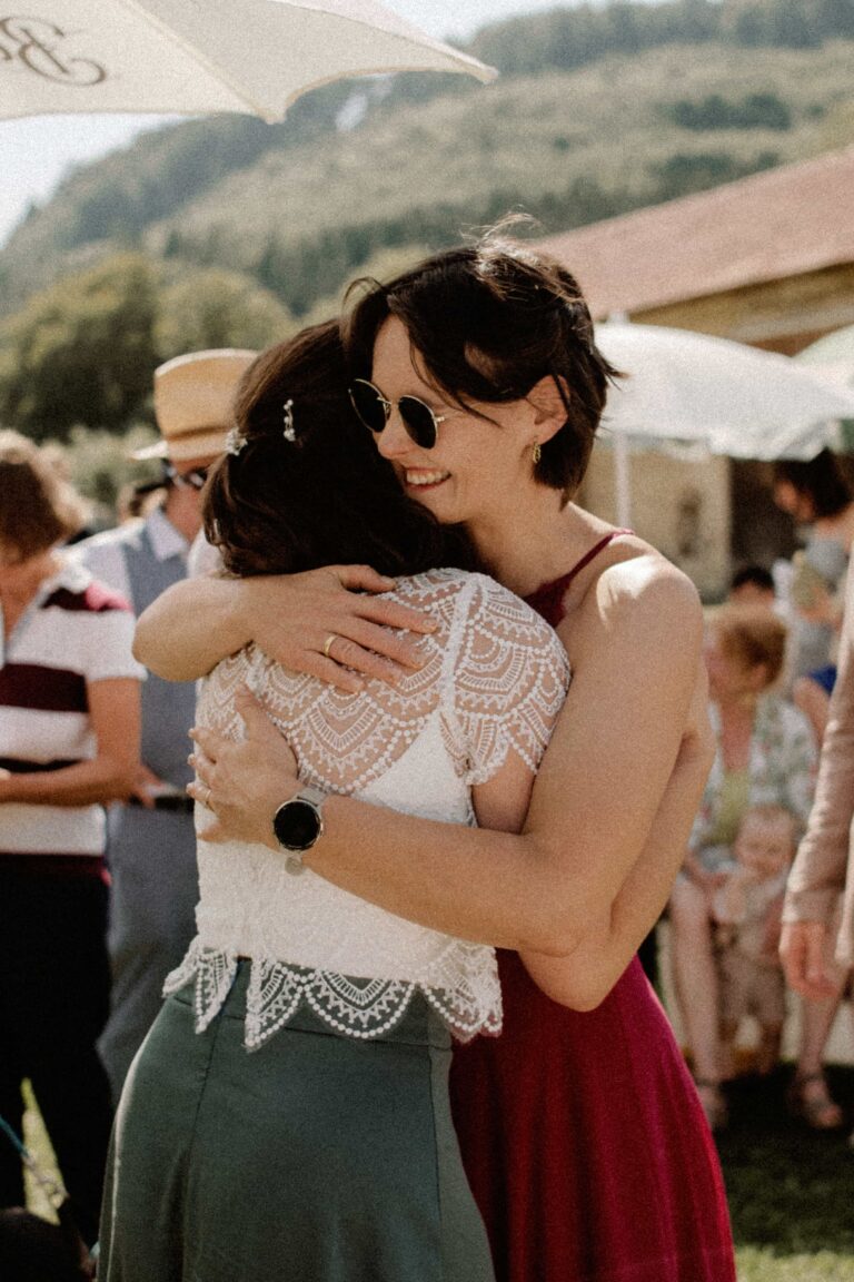 bride embracing friend at wedding