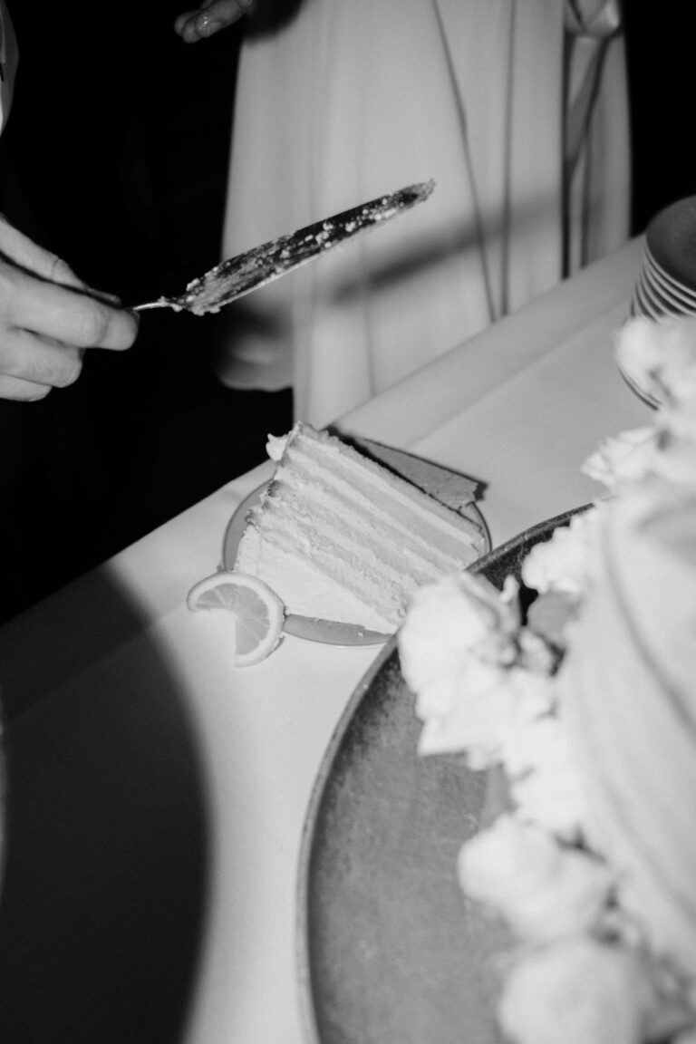 first piece of cake on a plate in black and white