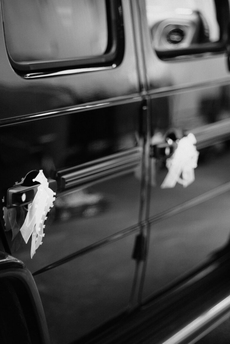detail of decorated car at wedding in black and white