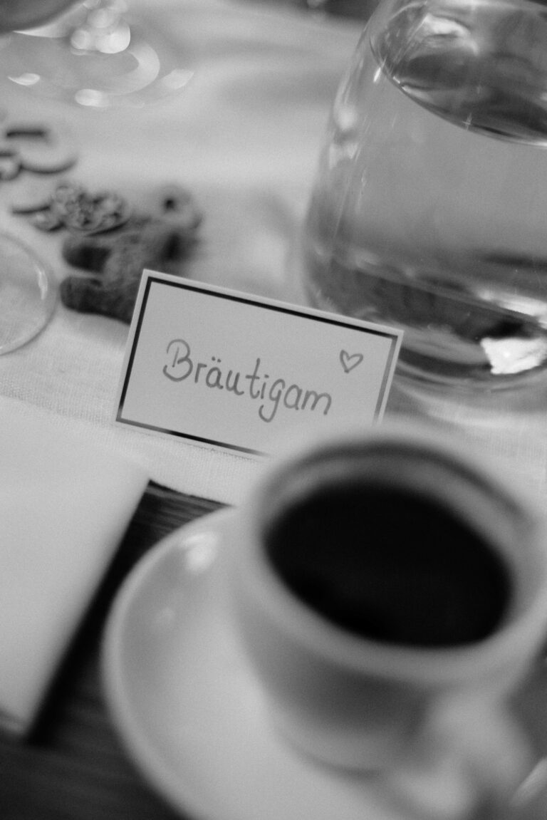 detail shot of coffee and name tag of groom in vintage black and white