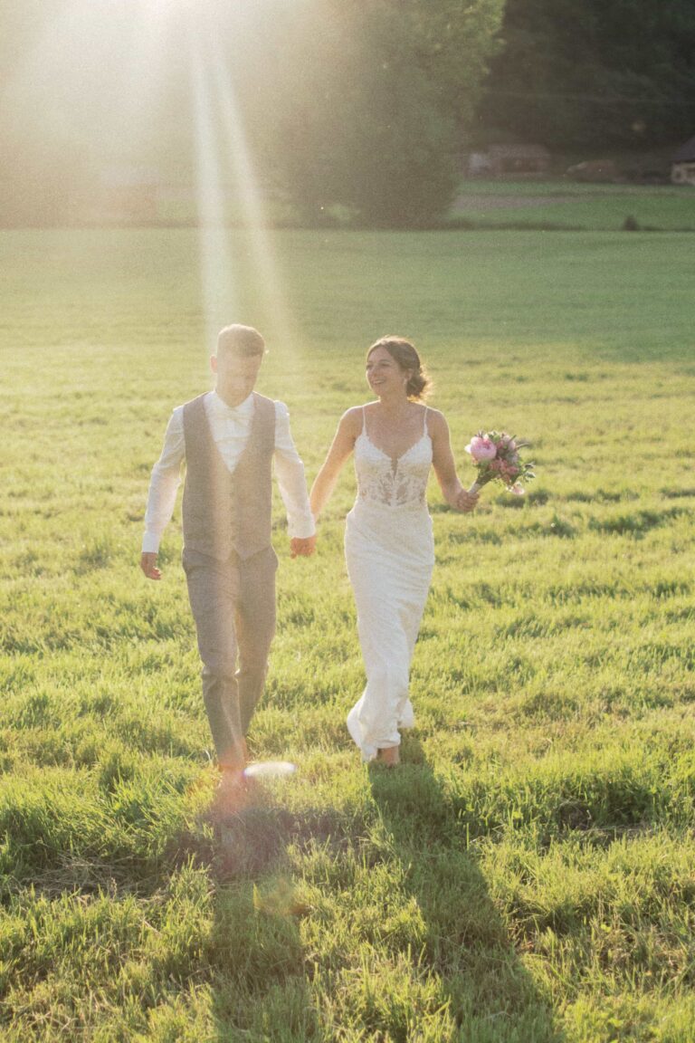 couple walking in sunset and gras
