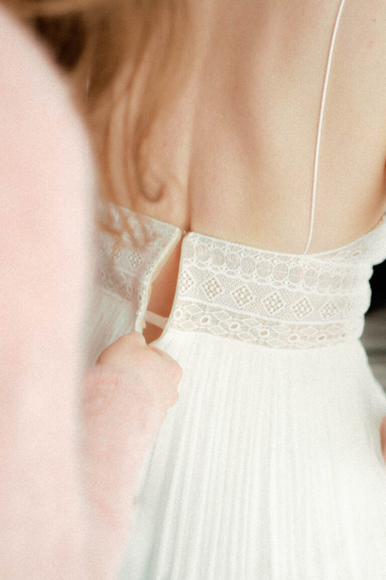 wedding dress getting zipped in analog look