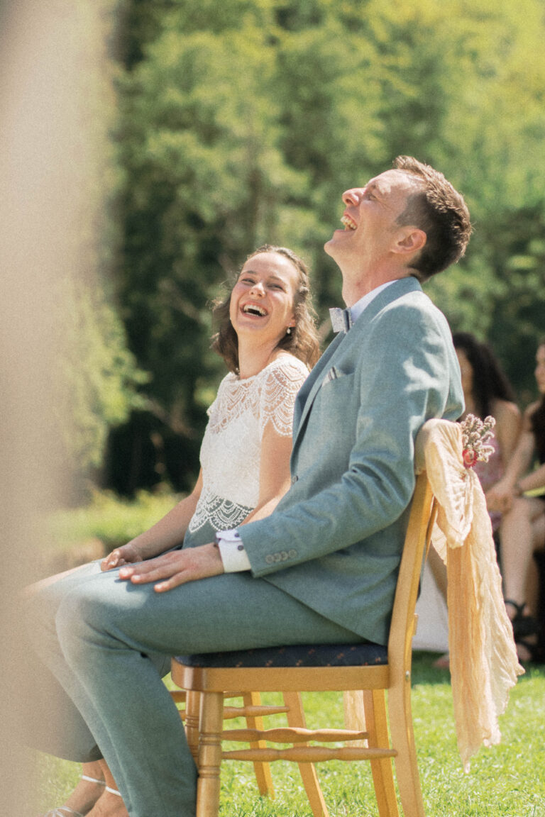 couple laughing at ceremony in the sun in vintage look