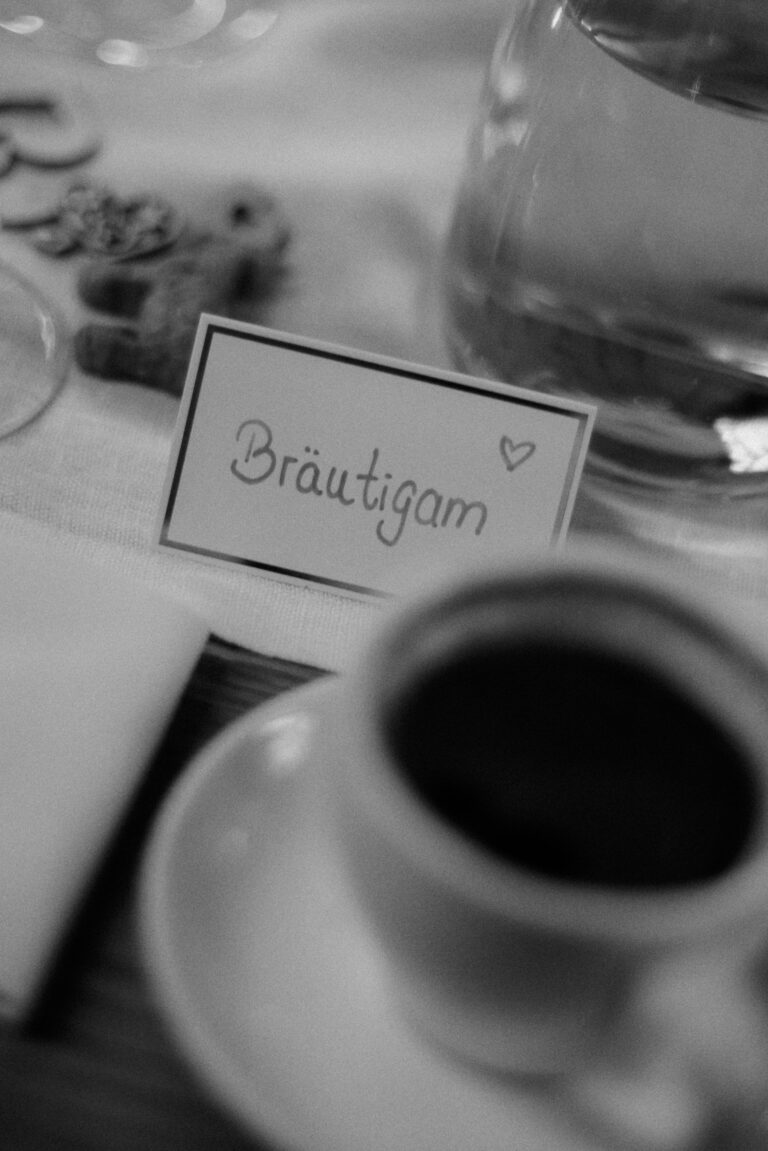 detail shot of coffee and name tag of groom in vintage black and white