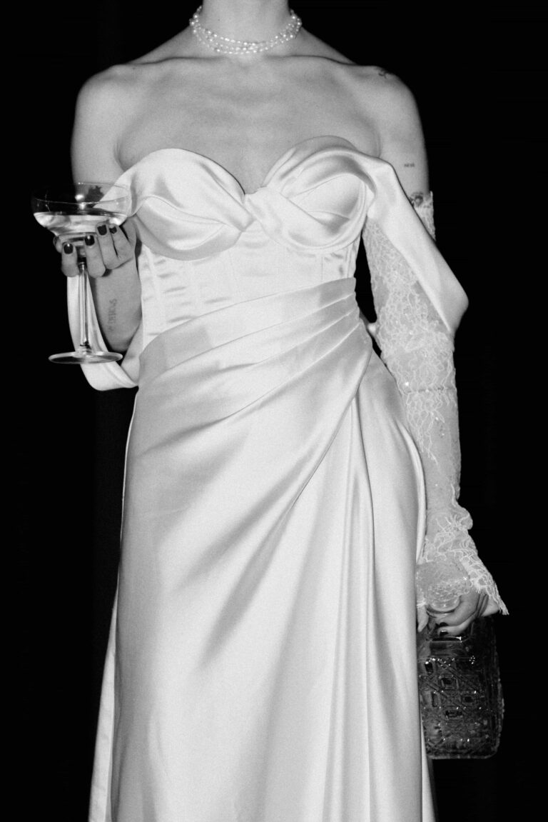 portrait of bride with glass and bottle in soft film tones