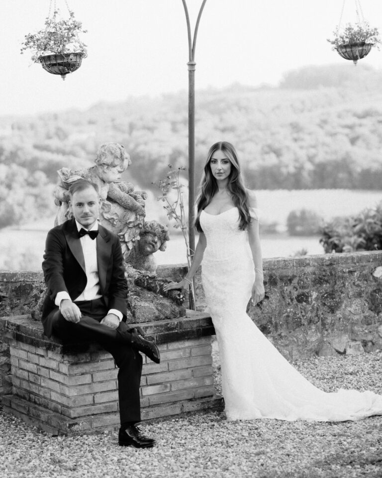 couple posing by statue